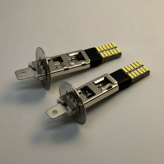 Two H1 LED bulbs on a gray background