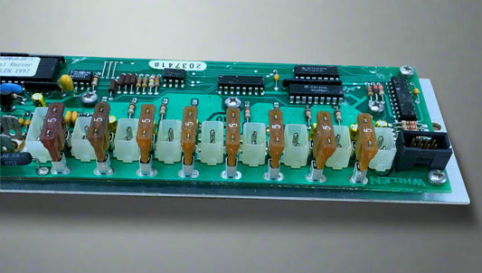 Vintage electronic circuit board for Whelen Edge 9000 lightbar, with various electronic components and connectors, predominantly green in color.