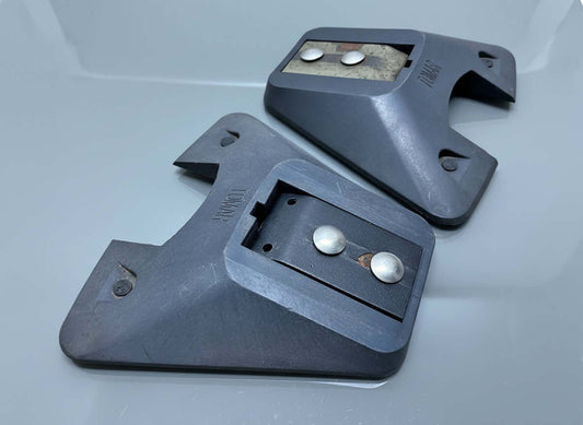 A pair of black mounting feet for a lightbar with visible rubber feet and metal hardware.